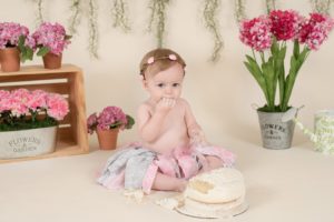 One year old girl eating her cake smash cake
